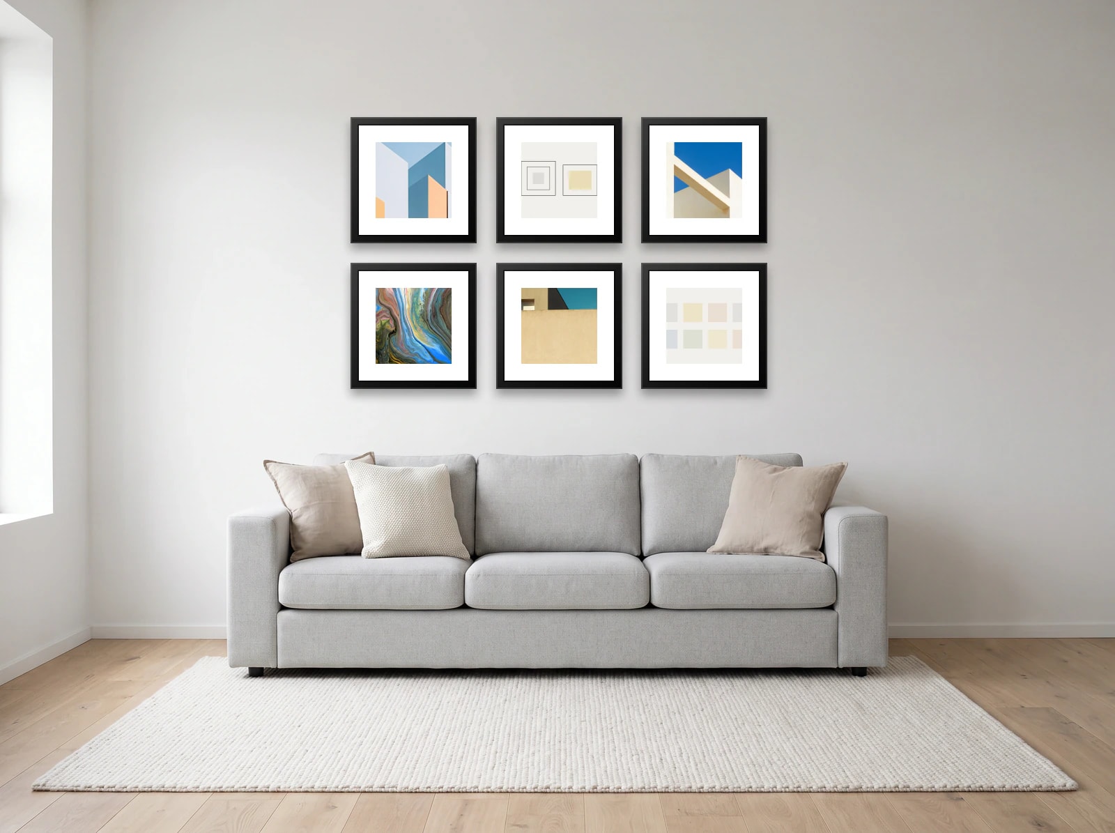 Grid gallery wall template: six 40 × 40 cm black frames in two rows above a light grey three-seat sofa on a white wall