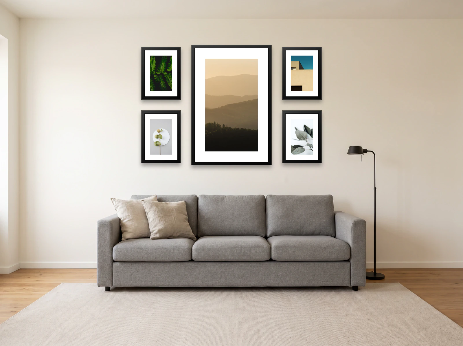 Gallery wall template above a grey sofa: one 61 × 91 cm frame between four 30 × 40 cm frames on a warm white wall