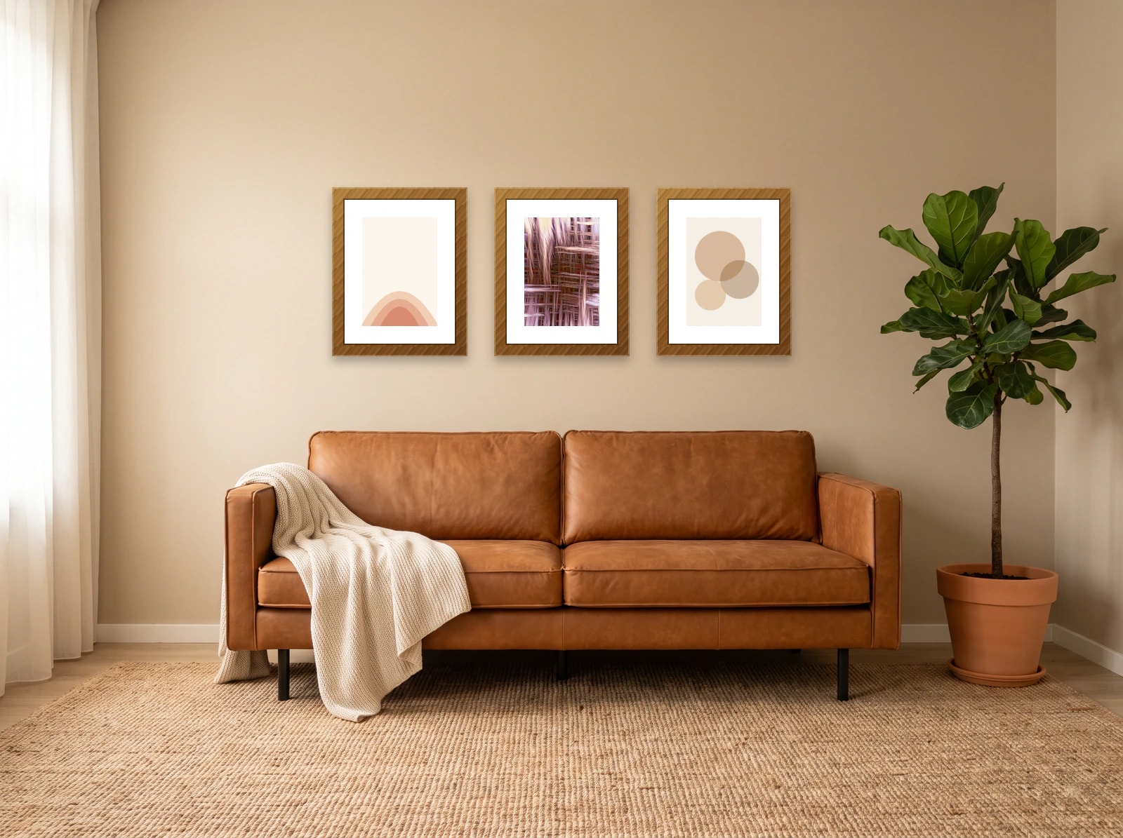 Gallery wall template above a couch: three 40 × 50 cm wood frames in a row over a cognac leather sofa on a warm beige wall