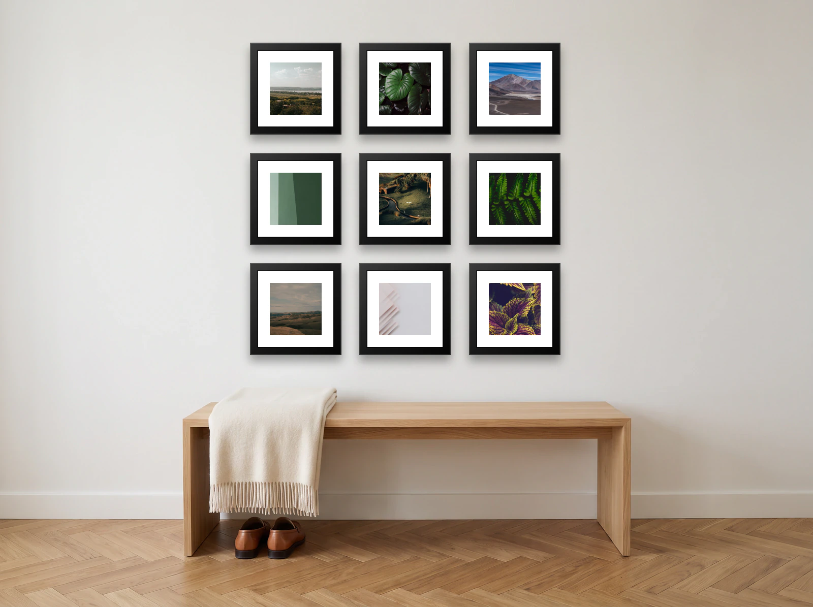 Family photo gallery wall template: nine 30 × 30 cm black frames in a three by three grid above an oak hallway bench