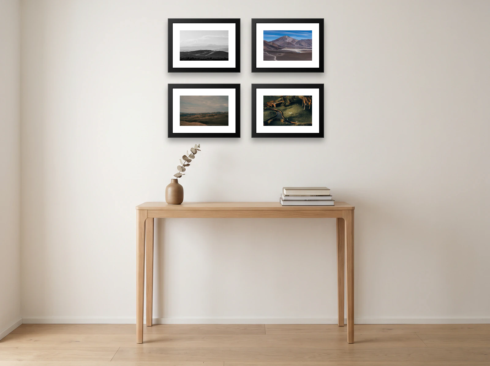 Family photo gallery wall template: four 40 × 30 cm black frames with white mats in a two by two grid above an oak console table