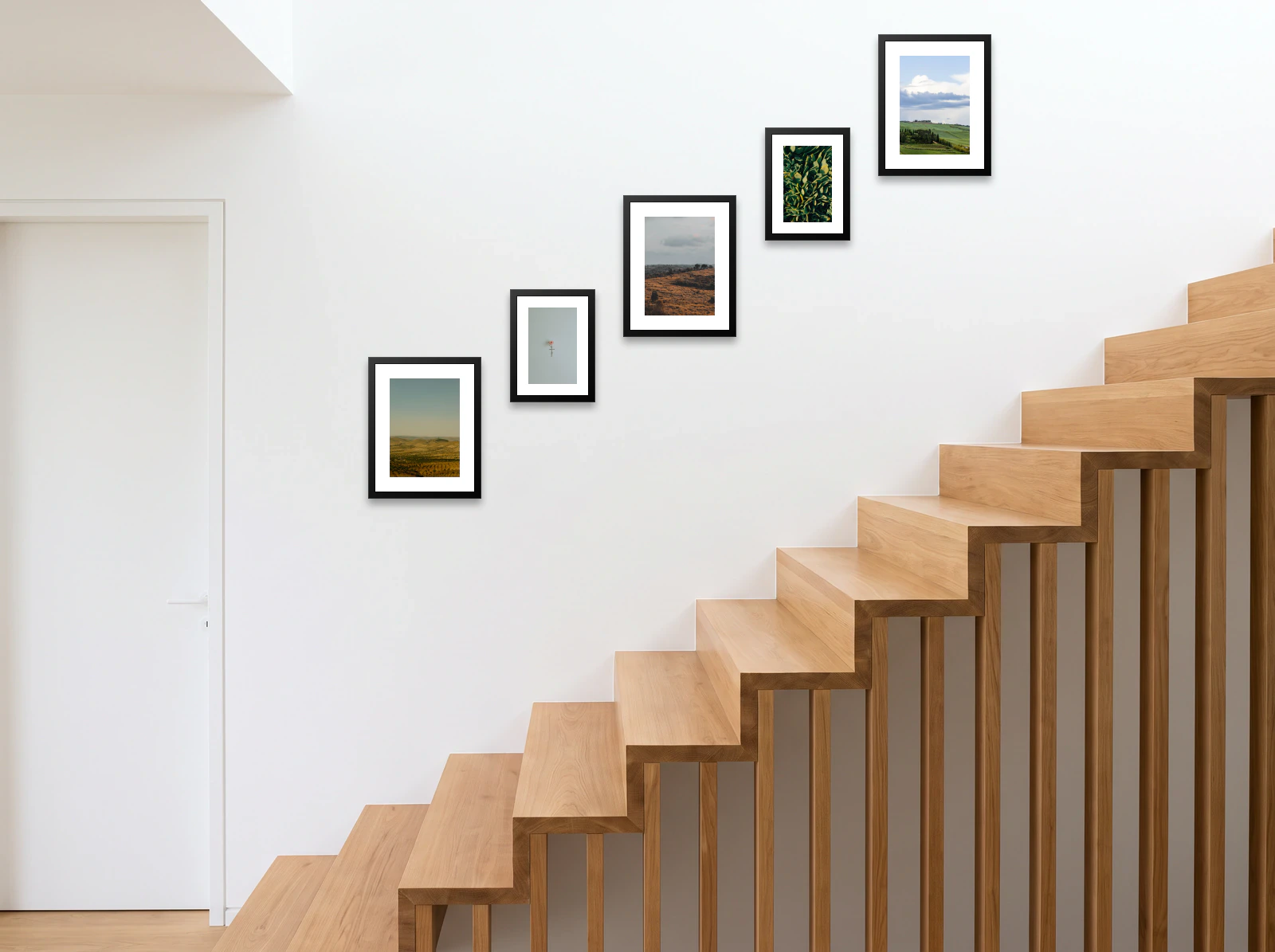 Staircase gallery wall template: five frames climbing a white wall above open oak stairs, alternating 40 × 50 cm and 30 × 40 cm