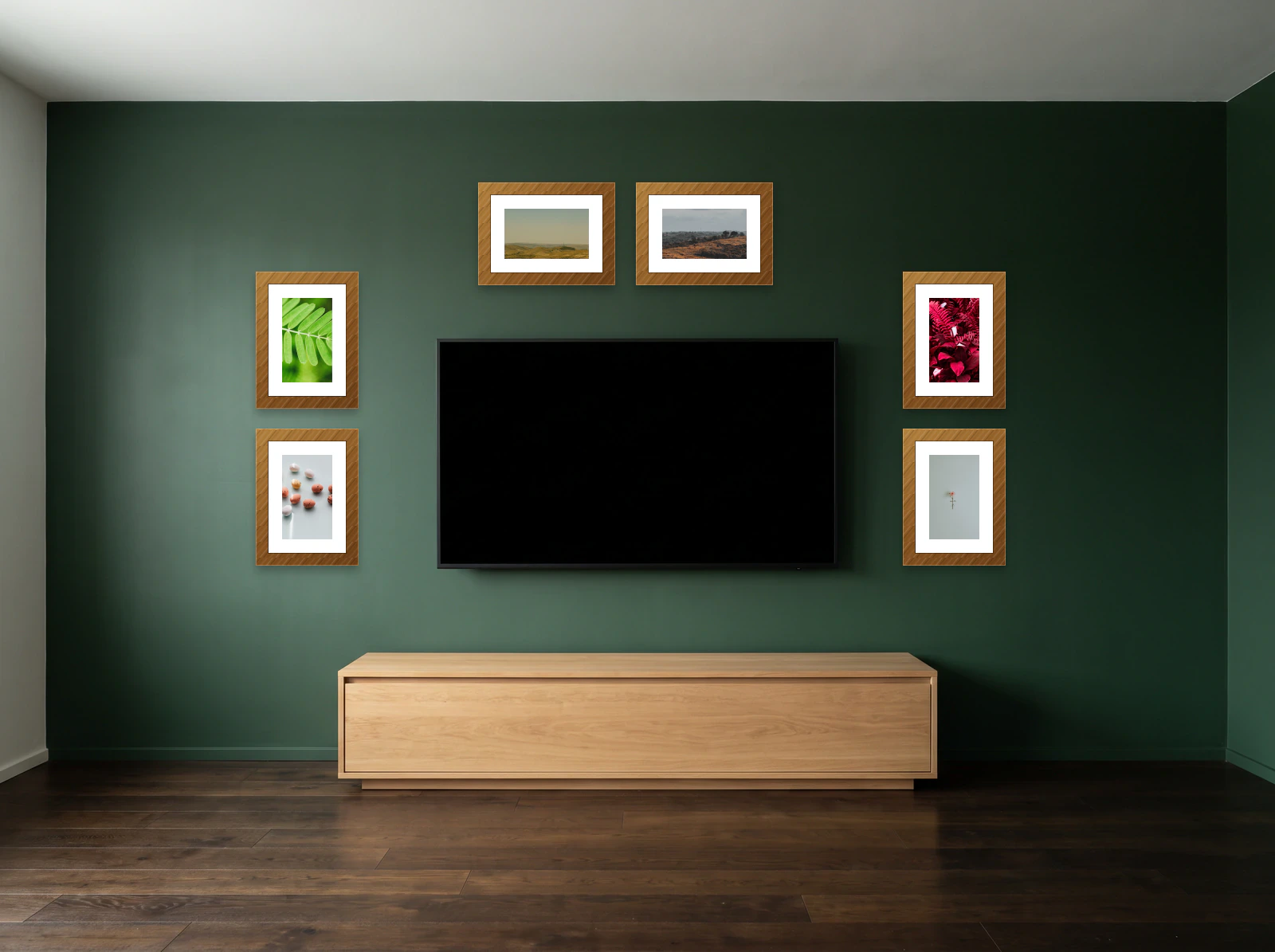 TV gallery wall template: six frames arranged around a wall-mounted television on a deep green wall above an oak media console